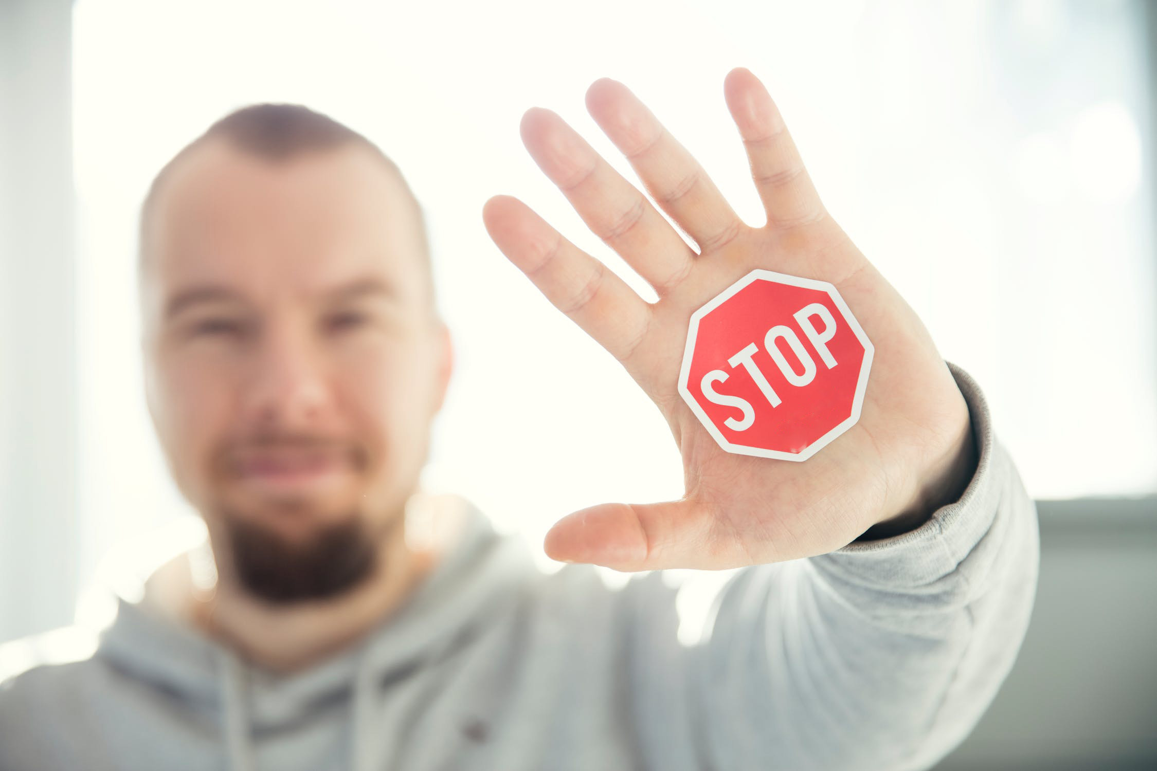 man holding a stop sign