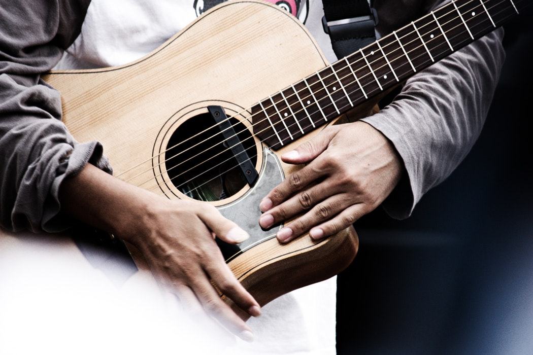 Man holding acoustic guitar