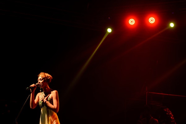 woman singing on stage