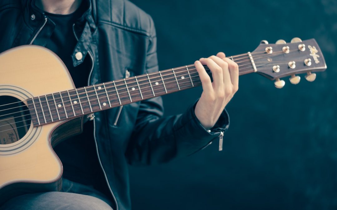 How to Hold a Guitar the Right Way: Our Guide - The Singer&#39;s Corner