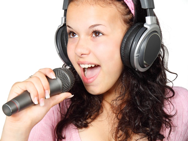 woman with headphones singing